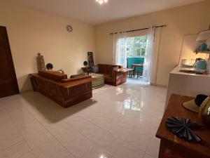 a living room with a couch and a table at Villa La Somone piscine jardin personnel sur place in Somone