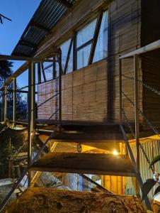 a house with a staircase up to the roof at Hospedaje Rural La Trinchera Mirador a la montañas Cerro Azul Trujillo in Trujillo