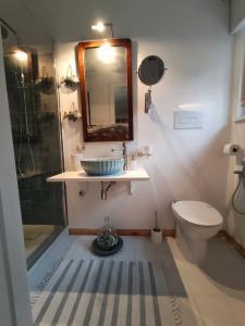 a bathroom with a sink and a toilet and a mirror at CASA CELESTE in San Nicola Arcella