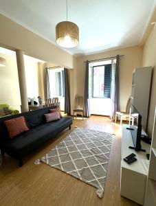 a living room with a couch and a table at Apartmento Centro Funchal in Funchal +7 photos
