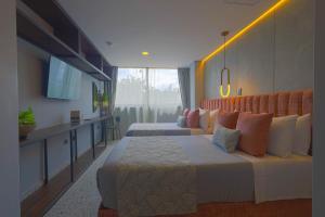 Postel nebo postele na pokoji v ubytování Hotel Glow Medellín