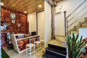 a bar in a room with a staircase and a stair case at Hotel O Kanchan Residency in Kota