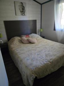 a bedroom with a bed with two stuffed animals on it at Cottage varrois in Solliès-Toucas