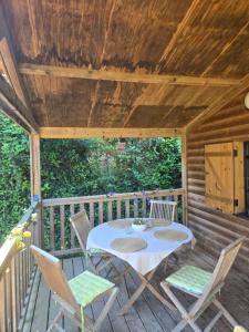 a patio with a table and chairs on a deck at Cottage varrois in Solliès-Toucas