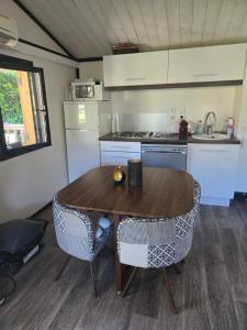 a small kitchen with a wooden table and chairs at Cottage varrois in Solliès-Toucas +5 photos