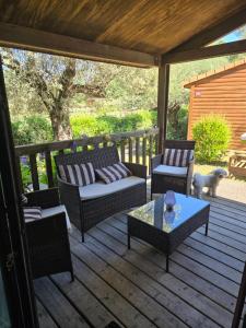 a patio with couches and a dog on a deck at Cottage varrois in Solliès-Toucas
