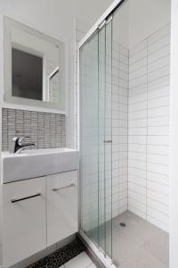 a bathroom with a glass shower and a sink at Spacious 3BR Retreat on City Fringe w Free Parking in Wellington