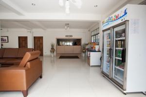 a living room with a couch and a store at Top Hostel (Top Mansion) in Udon Thani