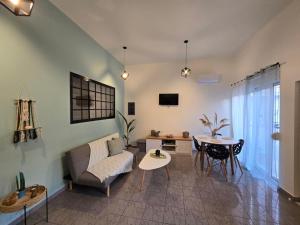 a living room with a couch and a table at Filoxenia house in Kremasti