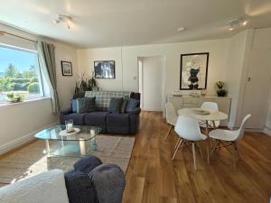 a living room with a couch and a table at Sweethaven Chalet in Killarone