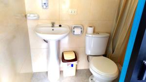a small bathroom with a toilet and a sink at Mountainview House Ollantaytambo in Ollantaytambo