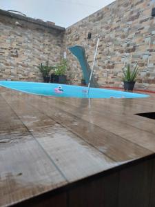 a blue surfboard sitting on top of a table at Casa de amigos e parentes in Eunápolis