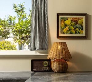 a lamp sitting on a table next to a picture of fruit at Carlsbad Cottage - Remodeled in Carlsbad