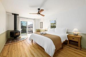 a bedroom with a bed and a wood stove at Carlsbad Cottage - Remodeled in Carlsbad +20 photos