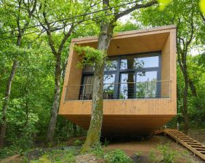 a tree house in the woods with a large window at Villa Marrakesh Noszvaj in Noszvaj