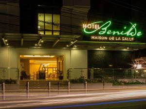 a hotel with a neon sign on the side of a building at Hotel Benilde Maison De La Salle in Manila