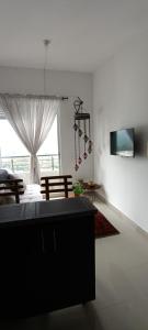 a living room with a couch and a window at atardeceres in Armenia