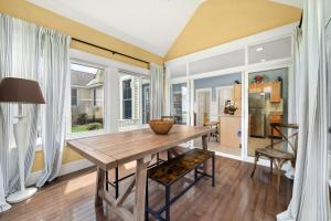 a dining room with a wooden table and chairs at The Cottontail - 6 Meadowview Lane in Cherry Valley