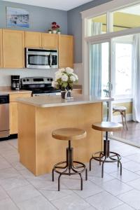 a kitchen with two bar stools and a counter top at The Cottontail - 6 Meadowview Lane in Cherry Valley +88 photos