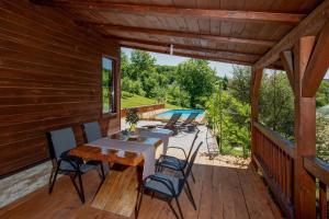 a patio with a table and chairs on a deck at Family friendly house with a swimming pool Varazdin Breg, Zagorje - 24411 in Sveti Ilija