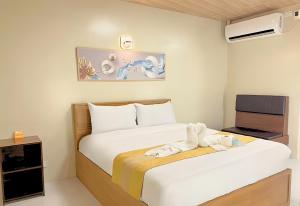 a hotel room with two beds and a tv at Algers Suites in Manila +13 photos