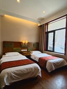 Postel nebo postele na pokoji v ubytování Beijing Huiqing Garden Bussiness Hotel