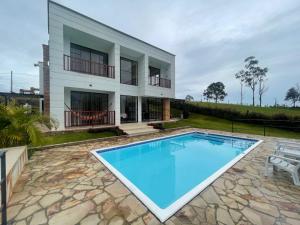a swimming pool in front of a house at Villa Lucero 143 in Los Santos
