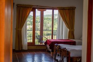 Postel nebo postele na pokoji v ubytování Hotel Campestre Cordillera de los Andes