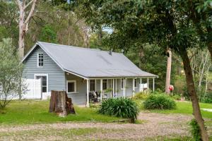 a small white house with a metal roof at Pottery Cottage, Alpine, Southern Highlands in Alpine
