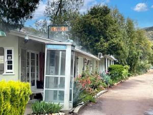 a phone booth in front of a house at Sierra Pelona Motel in Santa Clarita