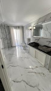 a white marble bathroom with a sink and a toilet at Luxury Sea View Penthouse, Monaco Border, 150m2, Parking in Beausoleil +14 photos