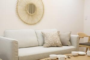 a living room with a couch and a mirror at オグラビル 203 in Tokyo