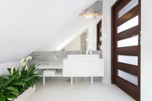 a bathroom with a white sink and a staircase at Apartamenty "Starówka" in Kazimierz Dolny