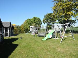a group of playground equipment in a yard at Holiday Home Dziwnówek near Baltic Sea in Dziwnówek +19 photos