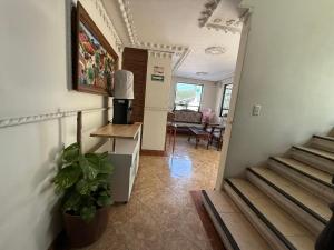 a hallway with a staircase and a living room at Hotel Arbis in Puebla