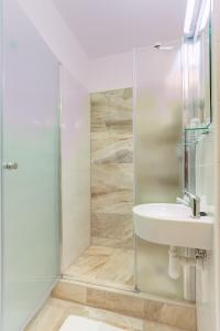 a bathroom with a sink and a shower at Hotel Lineas in Prešov