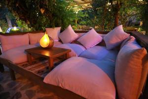 a large couch with pillows on it with a table at Dardanos Hotel in Patara