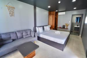 a living room with a bed and a couch at Queen Sea Resort - Đảo Phú Quý in Cu Lao Thu