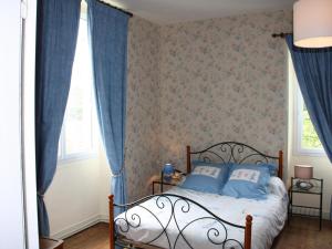 a bedroom with blue curtains and a bed with blue pillows at Maison XIXe, grand jardin clos, au cœur des vignobles, près de Chinon et de la Loire à Vélo - FR-1-381-445 in Beaumont-en-Véron