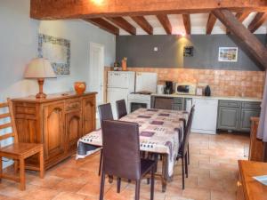 a kitchen with a table and chairs in a room at Gîte lumineux à Montrésor avec jardin privatif et équipements complets, proche du Zooparc de Beauval - FR-1-381-72 in Montrésor