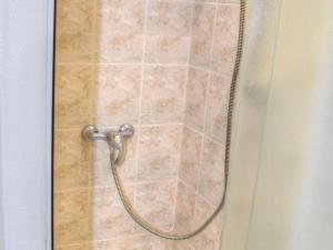 a shower with a shower head in a bathroom at Gîte lumineux à Montrésor avec jardin privatif et équipements complets, proche du Zooparc de Beauval - FR-1-381-72 in Montrésor +24 photos