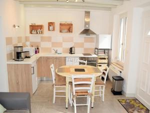 a kitchen with a table and chairs in a room at Gîte au Cœur du Val de Loire avec WIFI et Animaux Acceptés - FR-1-381-154 in Limeray