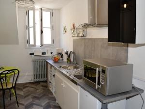 シノンにあるGîte 2 pers. avec terrasse, WIFI, proche des châteaux - FR-1-381-508の電子レンジ付きのカウンタートップを備えたキッチン