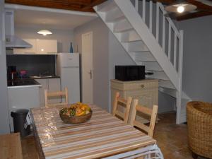 a kitchen with a table with a bowl of fruit on it at Gîte charmant à 30 min d'Amboise - FR-1-381-145 in Saint-Nicolas-des-Motets +20 photos
