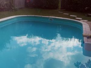 a swimming pool with a reflection of the sky in the water at Gîte calme au cœur de vignoble bio avec piscine, proche Azay-le-Rideau - FR-1-381-238 in Brizay
