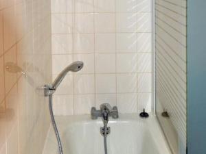 a bath tub with a shower head in a bathroom at Maison de campagne avec jardin privé, proche Châteaux de la Loire et Futuroscope. - FR-1-381-288 in Chaveignes +10 photos
