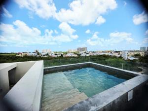 a swimming pool on the roof of a building at Mangle 13 Modern Apartments-Rooftop pool, close to Ferry in Cancún