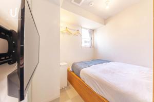 Postel nebo postele na pokoji v ubytování Hotel Residence Asakusa by unito