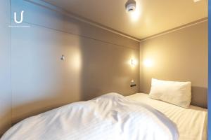 Postel nebo postele na pokoji v ubytování Hotel Residence Asakusa by unito
