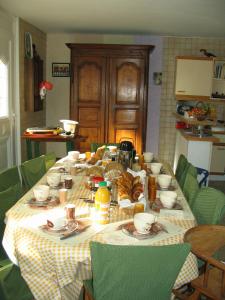a table with food on it in a kitchen at La Coutrotte Becquine in Heuilley-sur-Saône